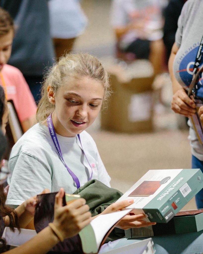 A student sorting donated supplies during a service project